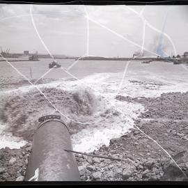 Dredging operations Newcastle harbour, dredging spoil gushing from pipe at Stockton, 1963