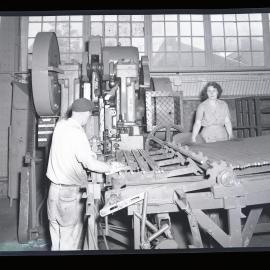 Two factory workers with machinery