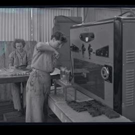 Two women working on Raydyne machinery