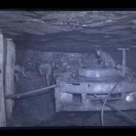 Men with machinery in coal mine