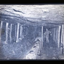 Miner operating coal belt