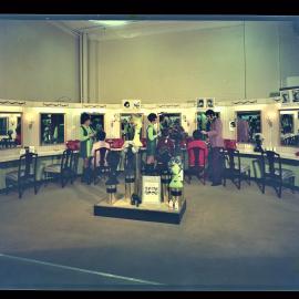 Three salon staff with clients, designer wigs