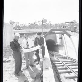 Men at a tunnel entrance, 1961