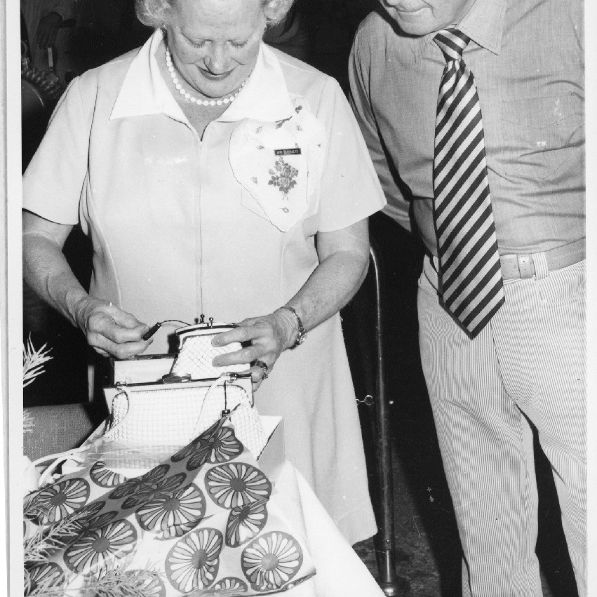 Mrs. Summers, left and Mr. Mathers, right, opening Mrs. Summer's retirement gifts, Royal Newcastle Hospital, Dietary Department, 1960s