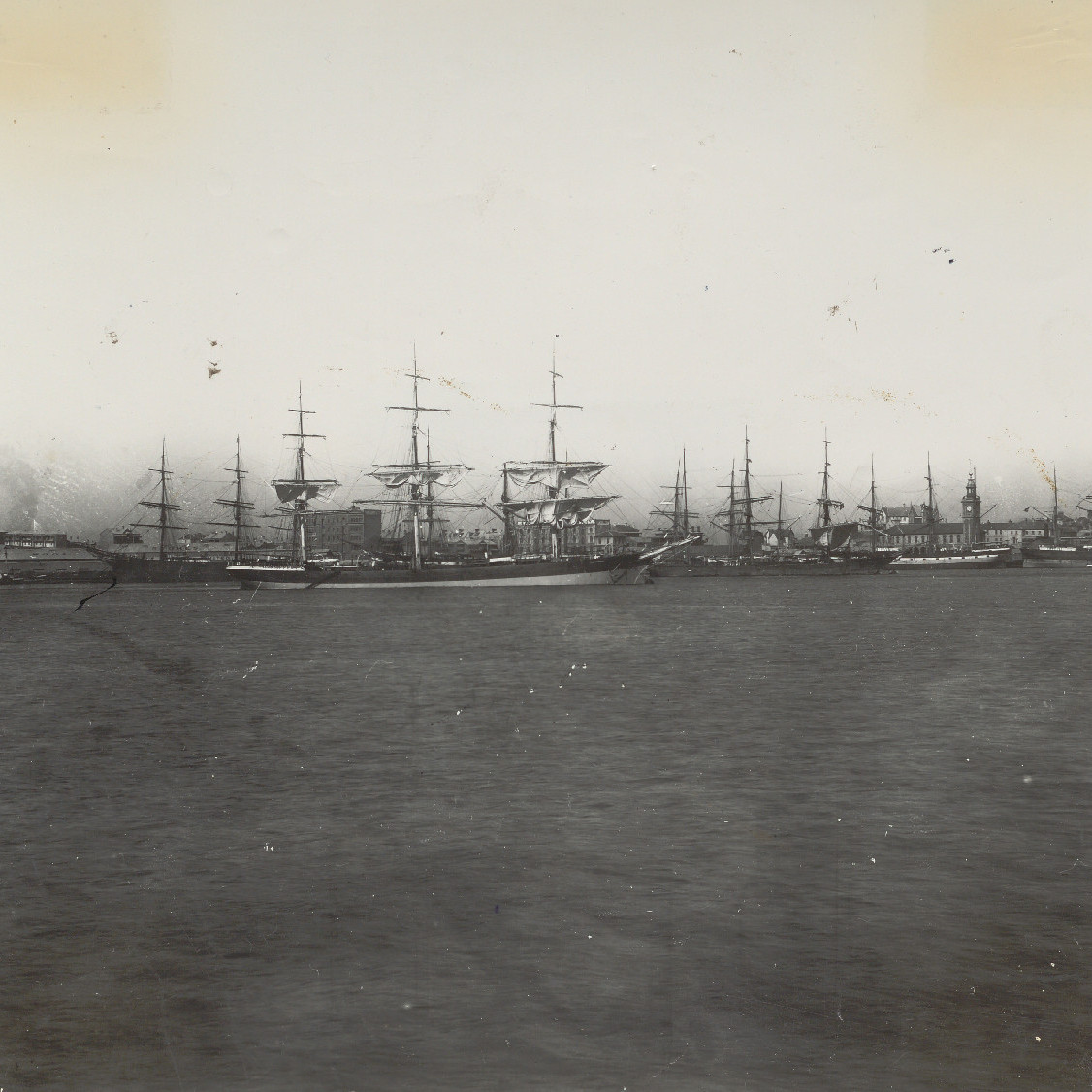 Ships Docked in Newcastle Harbour with City in Background