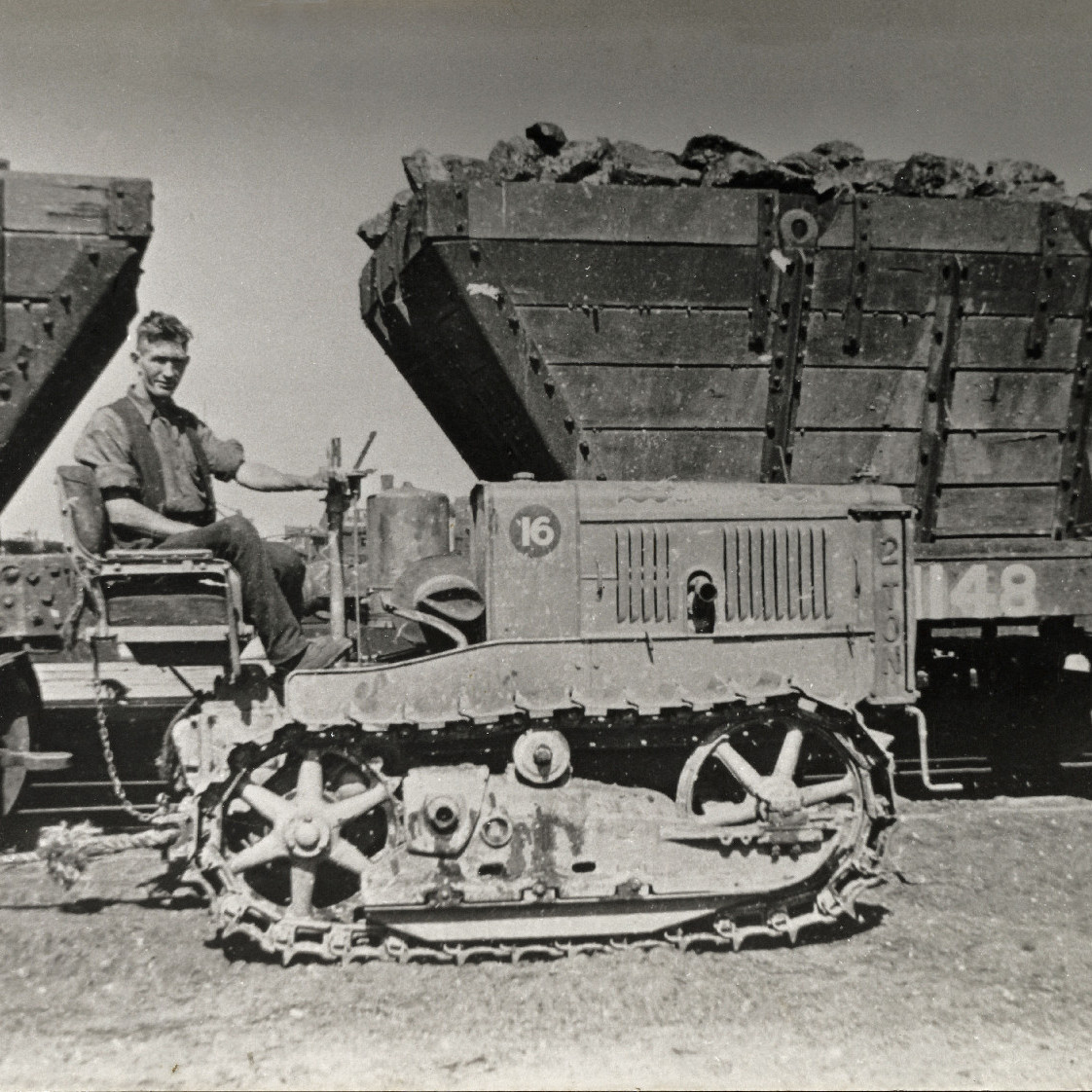 Man on tractor next to coal loaders