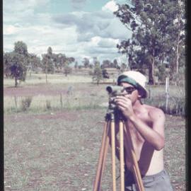 Unknown student surveying, unknown location [1960s]