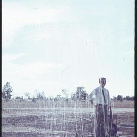 Student next to fountain under construction, unknown location [1960s]