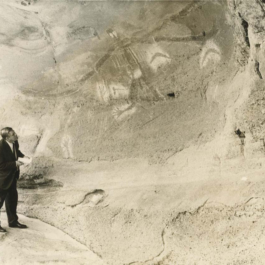 Percy Haslam viewing Aboriginal Rock Art Painting at Baiame Caves (Bo-anbee) at Millbrodale, 13 April 1974