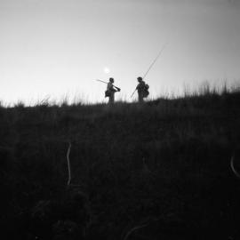 A shooter and fisherman meeting on the riverbank swapping yarns (Col Johnstone and Norm Mudd)