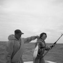 Dolly Dyer and Charlie Chambers holding a Striped Bonito