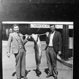 Horrie (sailor) Hopkins and Rex Asher with 62lb jewfish which they landed together at Stockton Beach, using 10lb. breaking strain gut line and beach rod