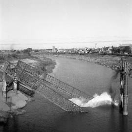 Old Belmore Bridge dropping into the river during demolition, Maitland, NSW,  1965