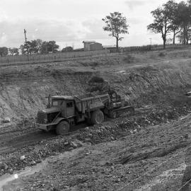 Tractor and truck making channel for Balickera Canal, NSW, 1963