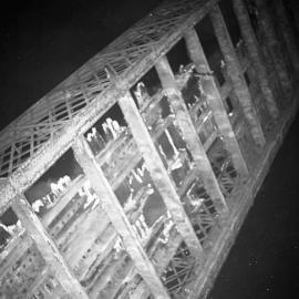 View from below, burning of decking of old Belmore Bridge during demolition, Maitland, NSW, June 12 1965