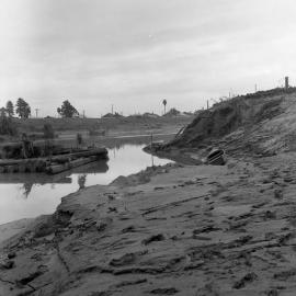 Erosion of embankment from flooding, Belmore Bridge, Maitland, NSW