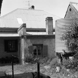 Water tank at rear of Eelah, Rosebrook Rd, Chakola, NSW, October 1973