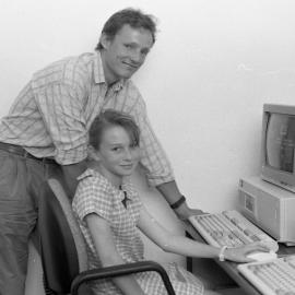 Rick Frost (Special Education) assists a child at a computer, the University of Newcastle, Australia - 1992