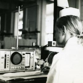 A nurse checks the condition of a patient in the coronary care section of the intensive care ward, Royal Newcastle Hospital, [late 1960s]