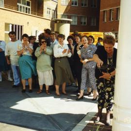 June Graham pouring champagne at the official opening of the Nickson wing porte cochere, coach door or carriage porch, Royal Newcastle Hospital, 19 September 1996