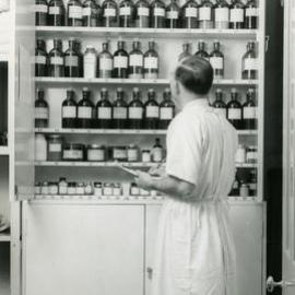 Inspecting a drug cupboard, Royal Newcastle Hospital's Pharmacy, Newcastle, NSW 