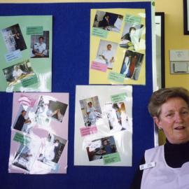 Mary Byrne, a "Pink Lady" in front of the display for Multicultural Health Week, Royal Newcastle Hospital, August 1999