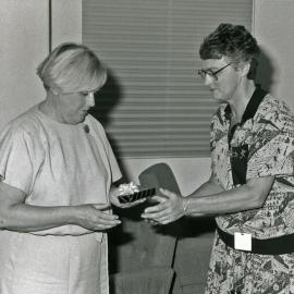 [Faye Woolley and] Deirdre Anderson, right, giving and receiving a gift, Royal Newcastle Hospital, [n.d.]