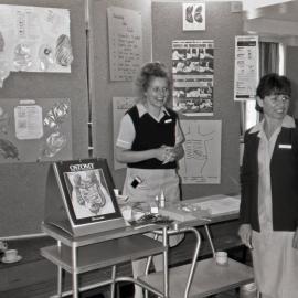 [Jill Fairhill and Vicki Parker] demonstrating how an ostomy bag works, Royal Newcastle Hospital, 1987