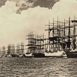 Nineteen Windjammers, "Carl Rudget Vinner", is on the outside of the first row of ships, Stockton, NSW, [1914]