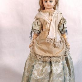 Wax doll on display stand [n.d.]