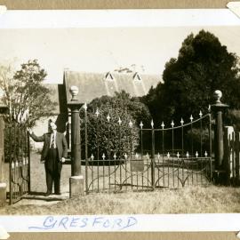 Mr Broadbent with pipe at gates of Church at Gresford, NSW, c. 1940s
