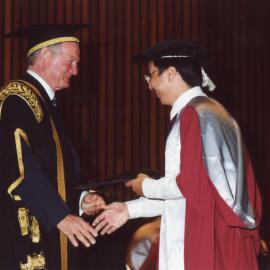 Chancellor Ric Charlton presents a PhD recipient with his award, the University of Newcastle, Australia - May, 2000