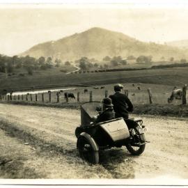 Brown Family Motor Cycle with side saddle near Rosebrook (NSW), c. 1940s.