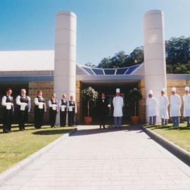 [Staff of the restuarant standing outside n.d.]