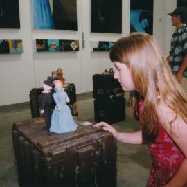 Child examining sculpture, Central Coast Campus art exhibition [n.d.].