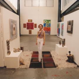 Alana Lewis with her work at a Central Coast Campus art exhibition.