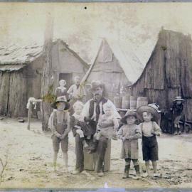 Family outside hut [on South Maitland Coalfields, NSW]