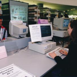 [unidentified students] using the Information Database PC's at the Central Coast Campus Library [n.d.] There appear to be journals in the background and the image was taken on the ground floor to the journals move upstairs.