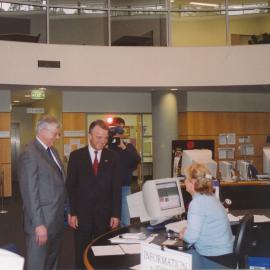 Brendan Nelson with Les Eastcott talking to librarian, Fiona Neville, in the library