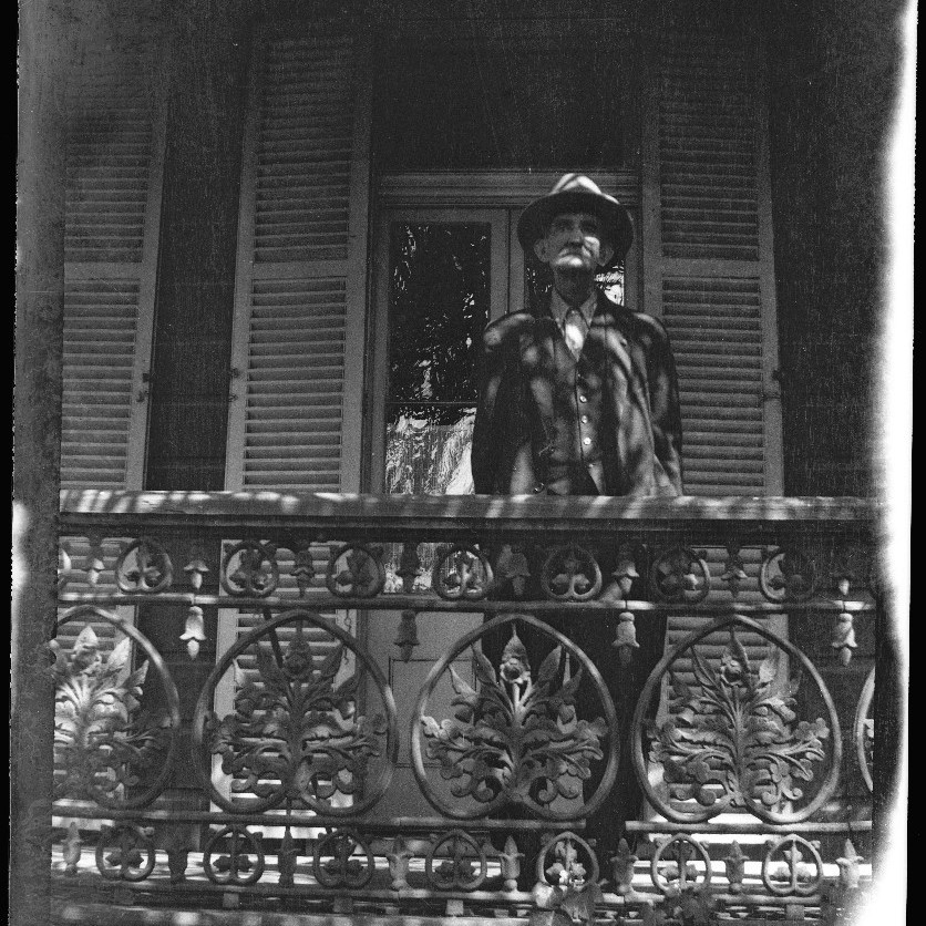 Unidentified man standing at balustrade at residence "Carclew' Waratah, NSW (film negative), c1920s