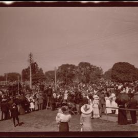 Public gathering at Hyde Park, Australian Museum on left at corner of Park and College Streets, Sydney NSW, c1914