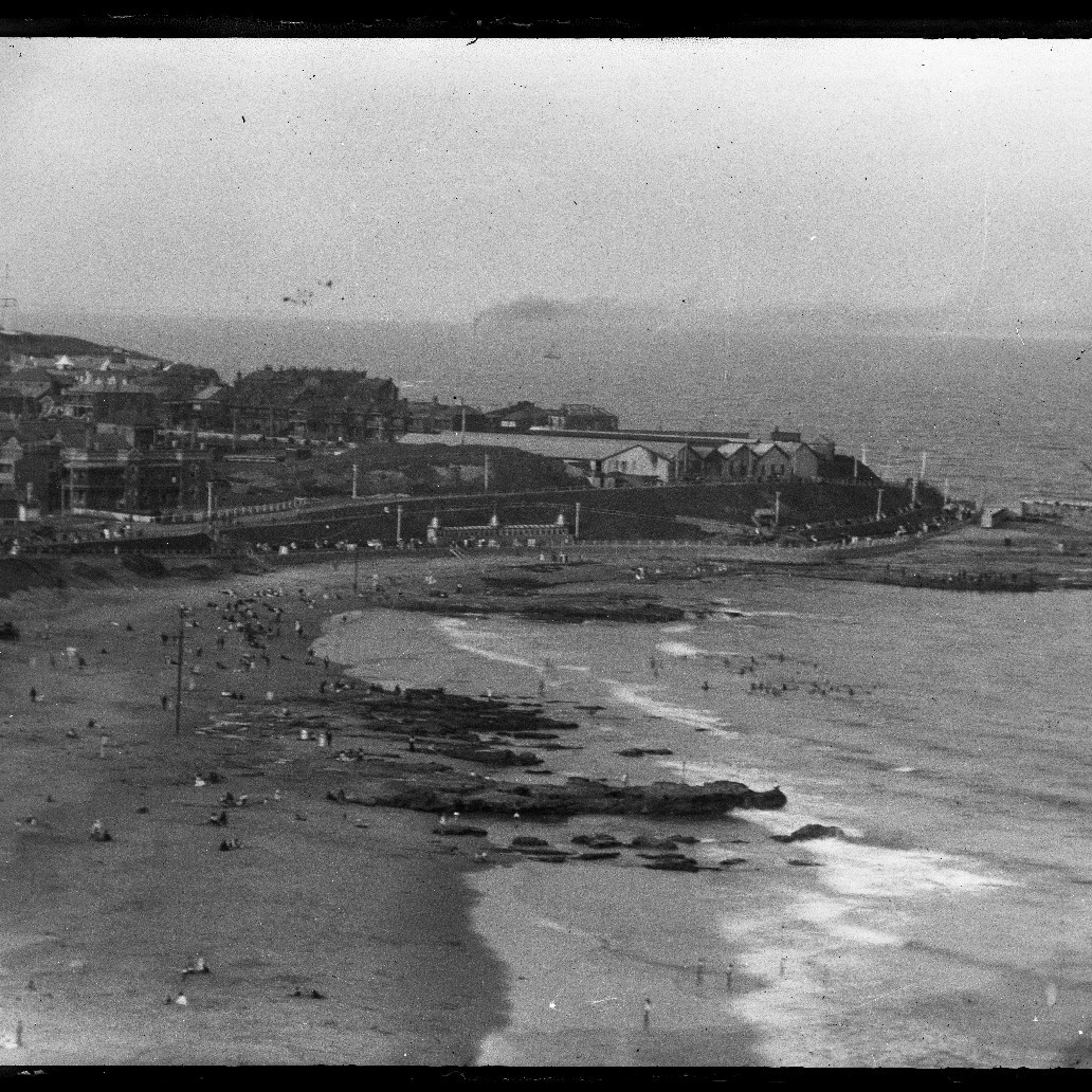 Newcastle Beach looking towards Newcastle East and Fort Scratchley, Newcastle Ocean Baths under construction, 1930s