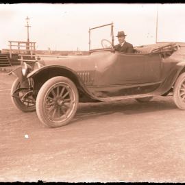 Unidentified man in automobile, circa 1920s