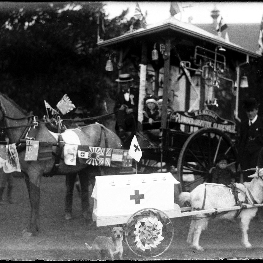 Comical fair attractions (sign on carriage reads "W.B.MacDuff. Plumber and gasfitter, Gladesville." with goat as ambulance, c1910s