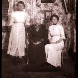 Three unidentified women in sitting room, c1910s