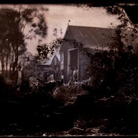 People outside building (damaged glass negative) c1910s