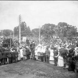 Public gathering at Hyde Park, Australian Museum on left at corner of Park and College Streets, Sydney NSW