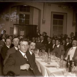 Gentlemen at banquet table, c1910s