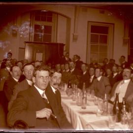 Gentlemen at banquet table, c1910s