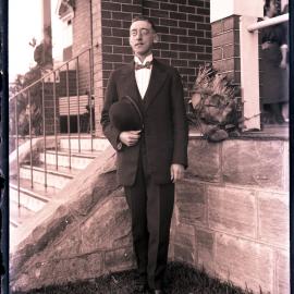 Unidentified man in suit, hat and neck tie.